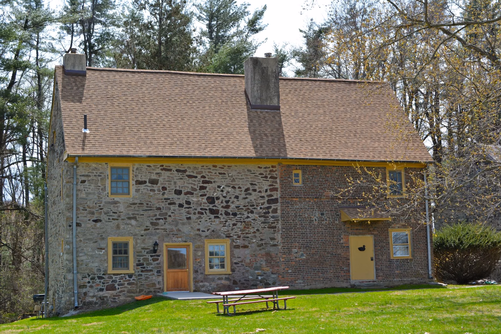 The Worrall house and lawn with a picnic table in Ridley Creek State Park